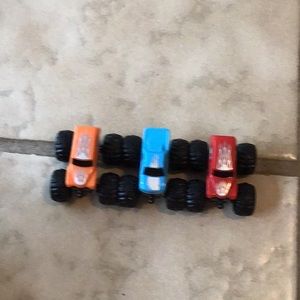 Three pack of micro mini cars that are red, orange, and blue.